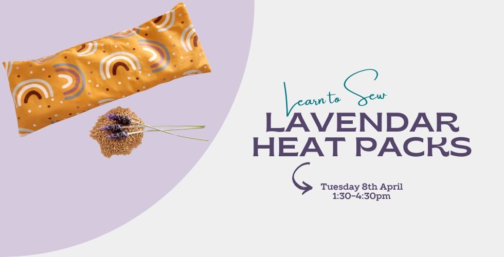 Mustard Lavender Heat Pack with rainbows printed on it. Lavender sitting on a pile of wheat under the heat pack
